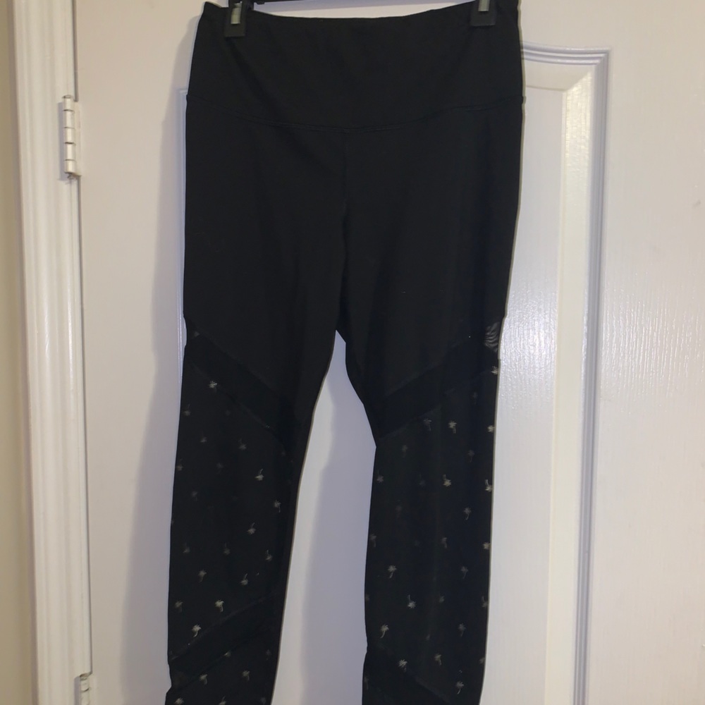 black leggings with palm tree designs on the legs